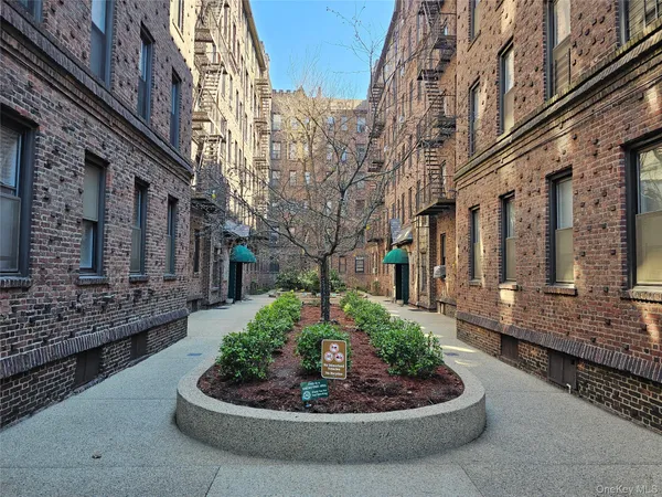 a front view of a multi story building with yard