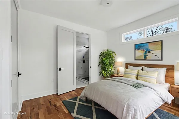 a bedroom with a bed and a painting on the wall