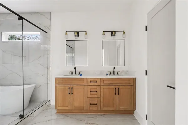 a bathroom with a granite countertop sink a toilet and shower