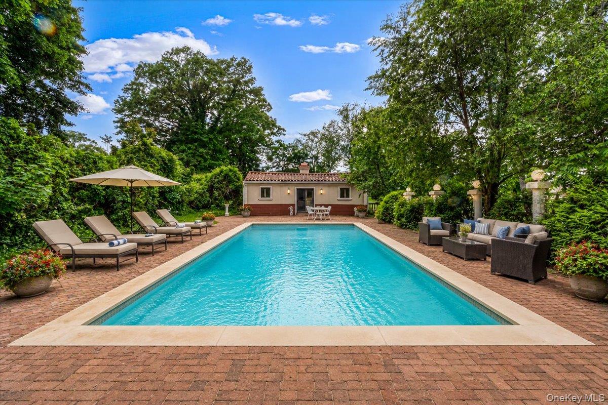 952 Cedar Swamp Road Glen Head, NY 11545 - Photo 45 of 50 a small pool with lawn chairs under an umbrella