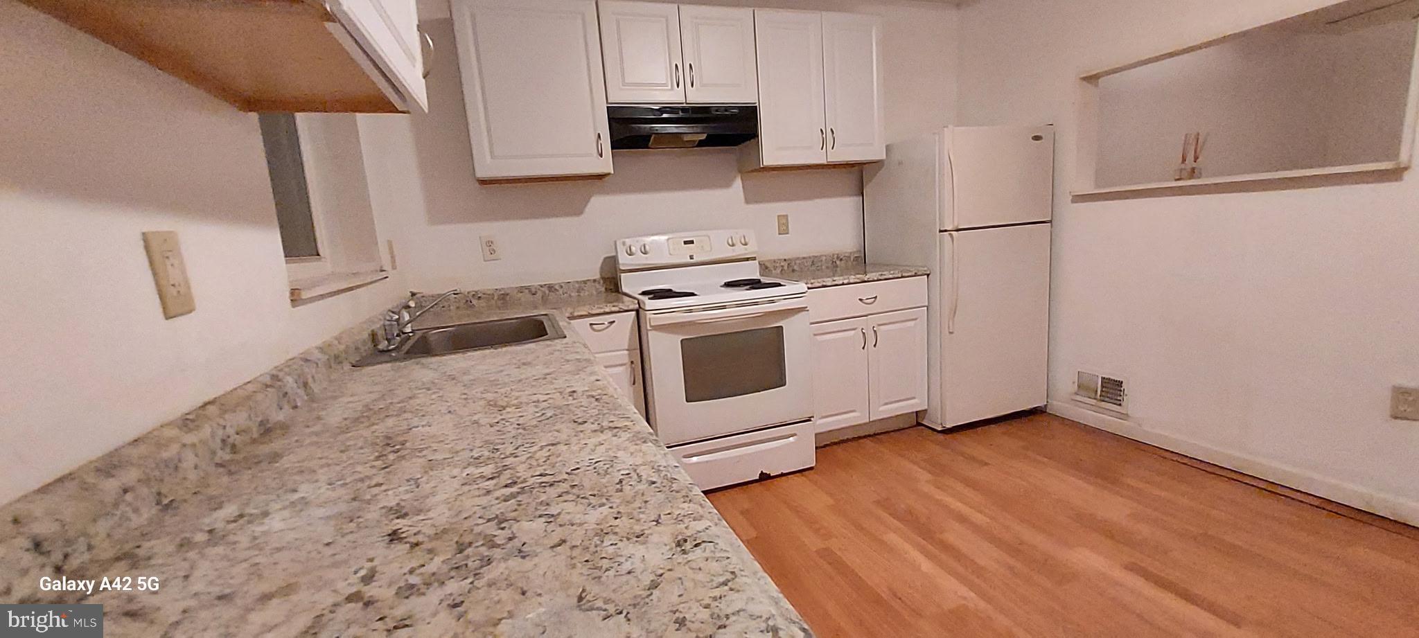 2516 Lauretta Avenue Baltimore, MD 21223 - Photo 2 of 4 a kitchen with stainless steel appliances a stove a sink and a refrigerator