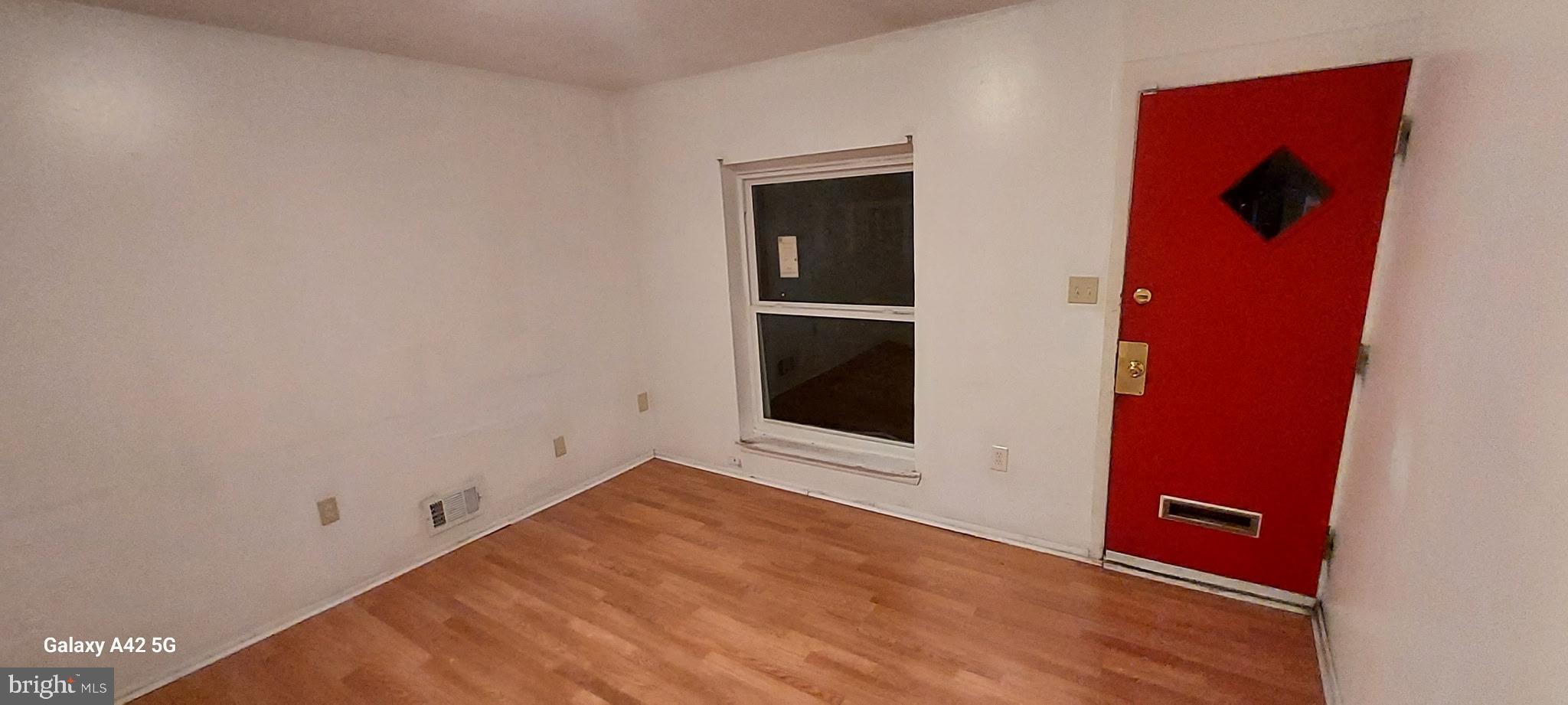 2516 Lauretta Avenue Baltimore, MD 21223 - Photo 4 of 4 a view of an empty room with wooden floor and closet