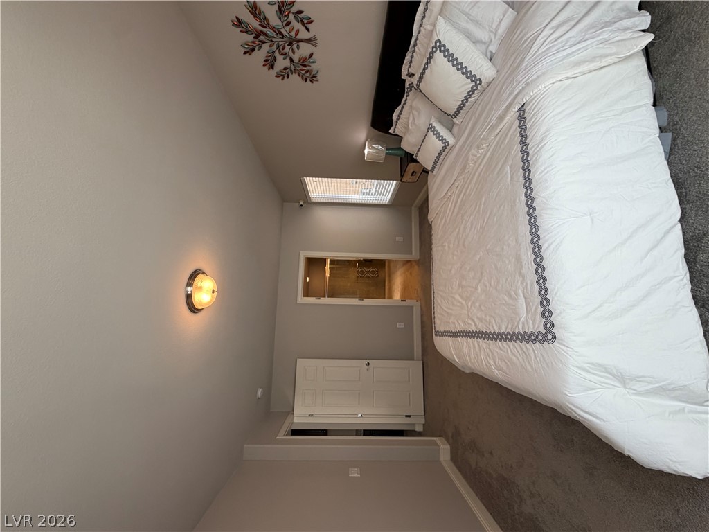 6385 Jackson Spring Road Las Vegas, NV 89118 - Photo 29 of 36 A well-appointed bedroom featuring a vaulted ceiling, offering a peaceful retreat.
