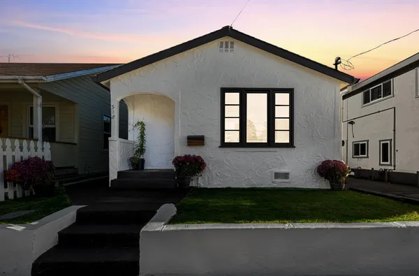a front view of a house with a yard