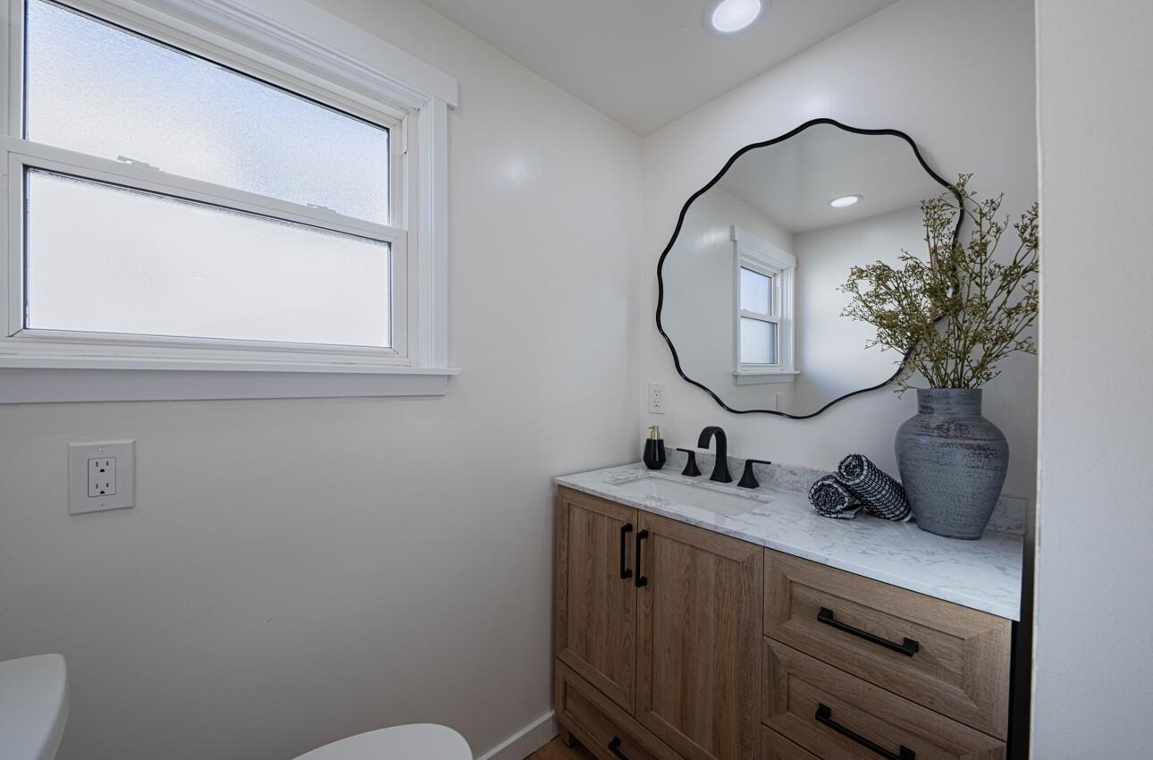 518 Cortes Street Monterey, CA 93940 - Photo 14 of 32 a bathroom with a sink mirror and vanity
