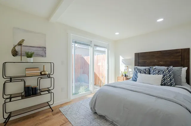 a bedroom with a bed a desk and chair