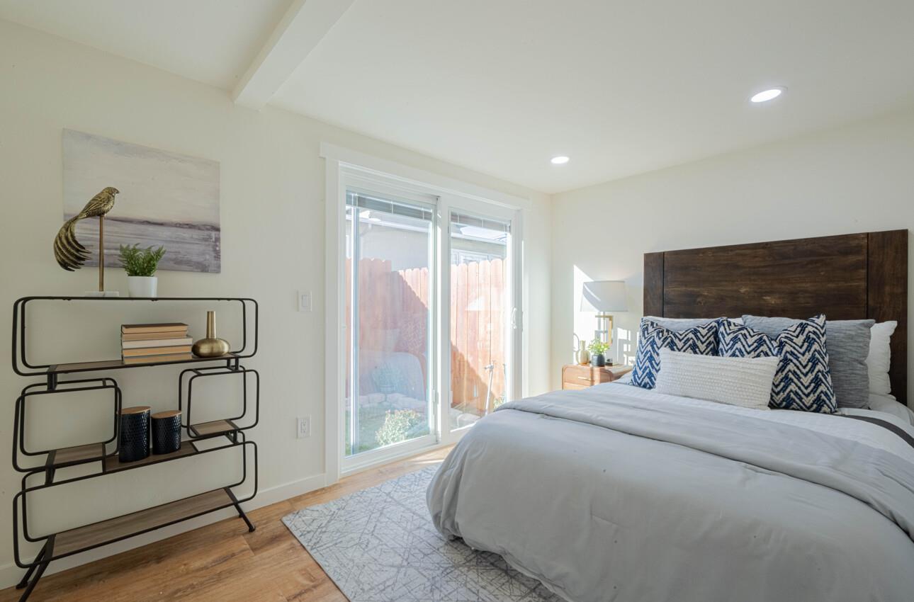 518 Cortes Street Monterey, CA 93940 - Photo 15 of 32 a bedroom with a bed a desk and chair