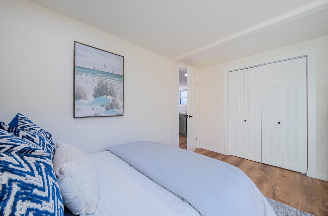 518 Cortes Street Monterey, CA 93940 - Photo 16 of 32 a bedroom with a bed and a painting on the wall