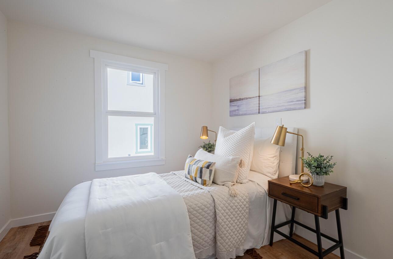 518 Cortes Street Monterey, CA 93940 - Photo 21 of 32 a bedroom with a bed table chair and a window