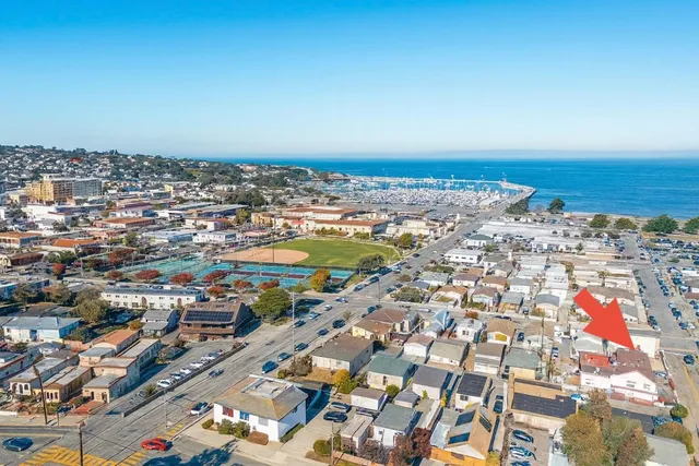 an aerial view of residential building and car parked