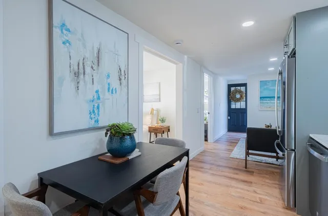 a view of a workspace with furniture and wooden floor