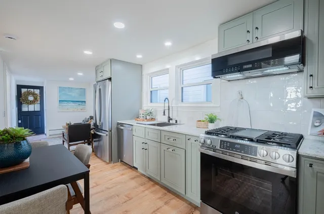 a kitchen with a stove and a white cabinets