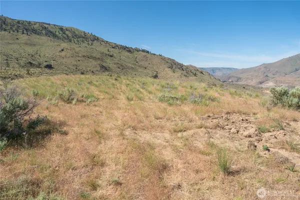 a view of dirt yard with mountain view