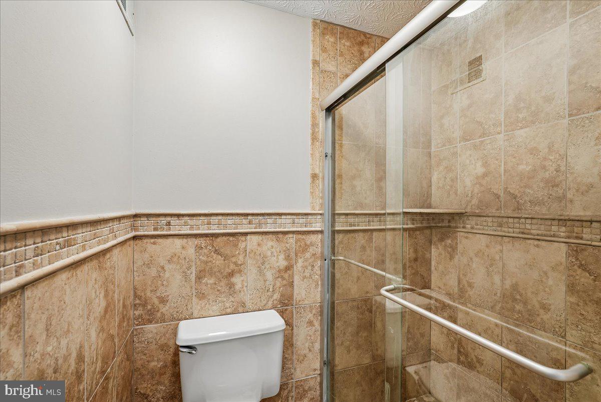 2331 Middle Creek Lane Reston, VA 20191 - Photo 29 of 78 a bathroom with a toilet and a shower