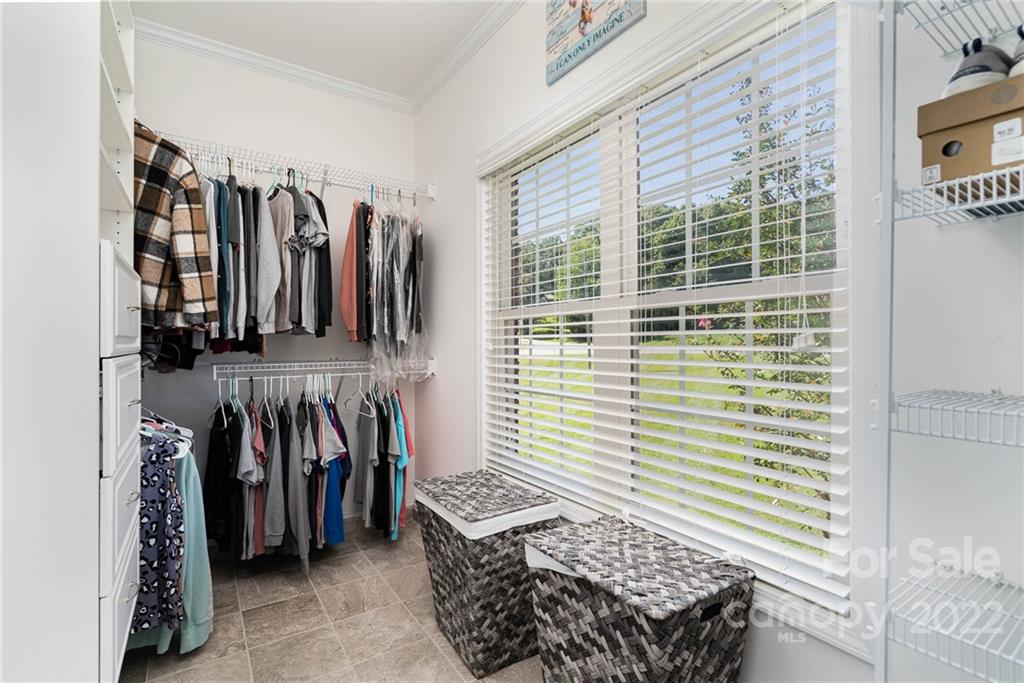 7920 Mt Olive Road Concord, NC 28025 - Photo 19 of 43 a view of walk in closet with clothes and shoes
