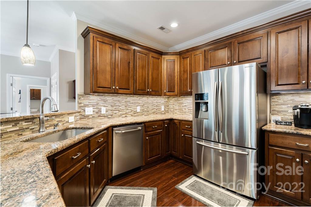 7920 Mt Olive Road Concord, NC 28025 - Photo 5 of 43 a kitchen with stainless steel appliances granite countertop a refrigerator a sink dishwasher a stove top oven a refrigerator and cabinets
