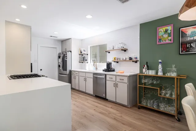 a kitchen with a sink stove and refrigerator