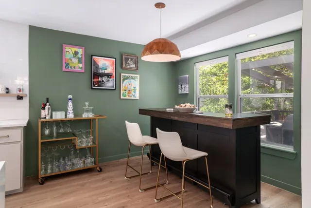 a dining room with wooden floor and a window