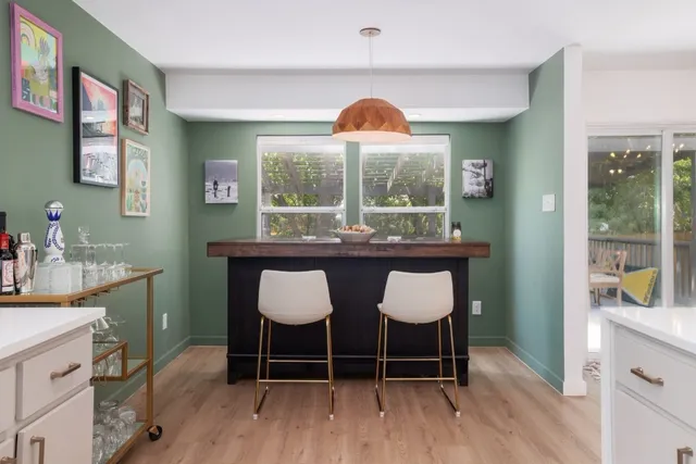 a large kitchen with cabinets and wooden floor