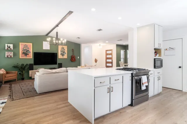 a bedroom with a large bed and a chandelier