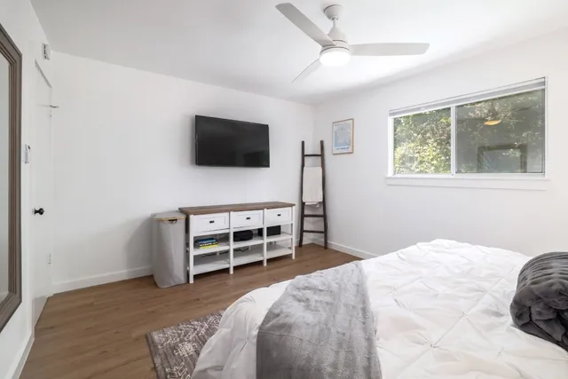 a bedroom with a bed and a flat screen tv