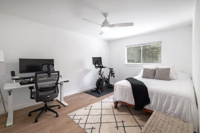 a view of a workspace with furniture and wooden floor