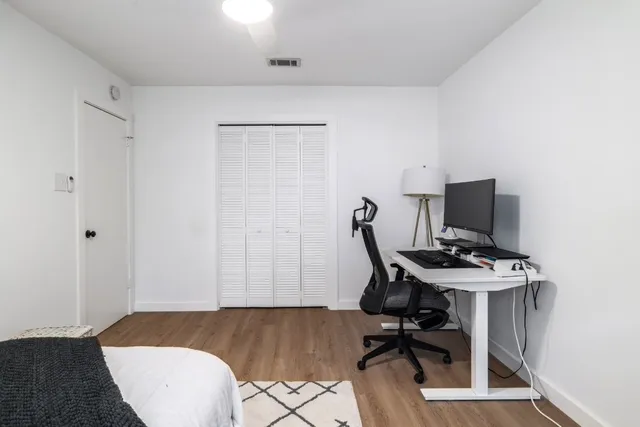 a bathroom with a double vanity sink toilet and a mirror
