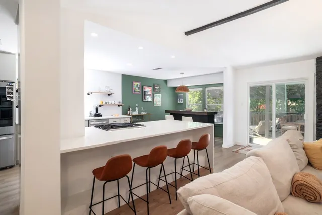 a kitchen with stainless steel appliances kitchen island granite countertop a sink and cabinets