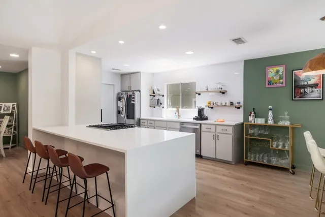 a kitchen with a sink cabinets and wooden floor