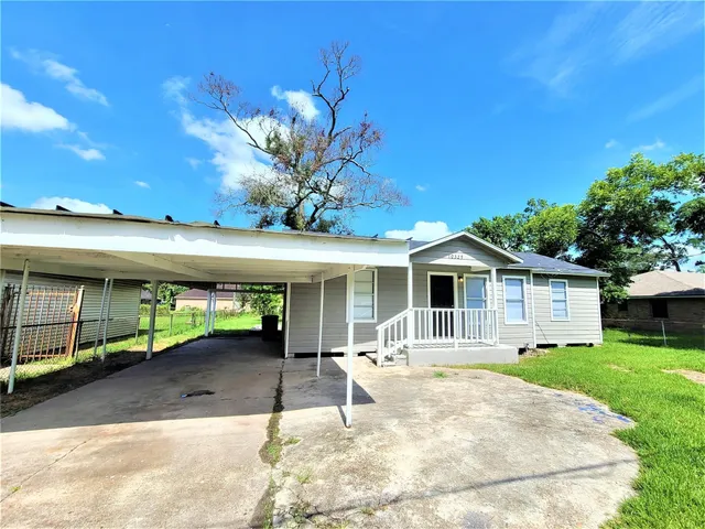 a backyard of a house with yard and outdoor seating