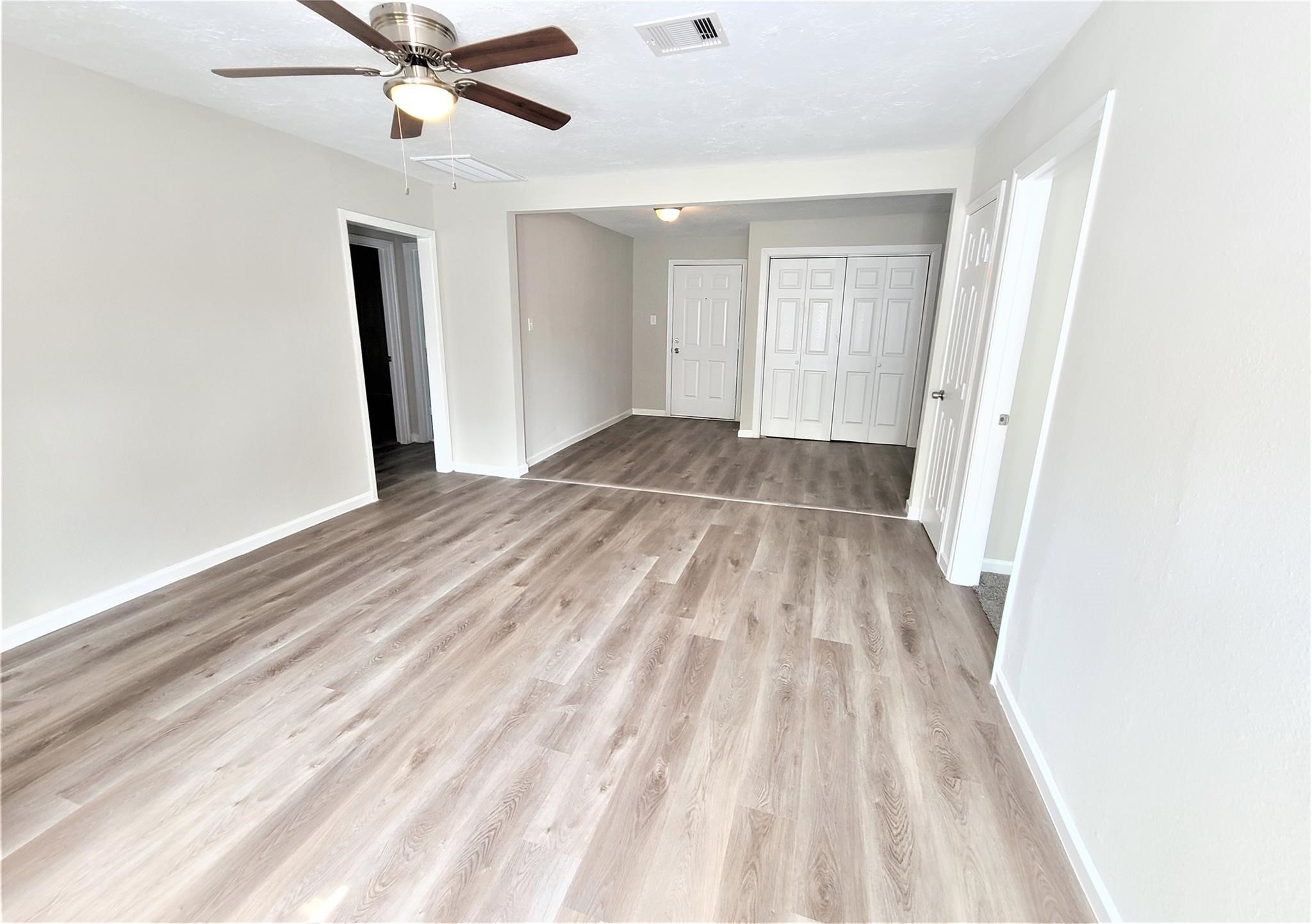 10329 Wicklowe Street Houston, TX 77016 - Photo 2 of 10 a view of a room with wooden floor a ceiling fan