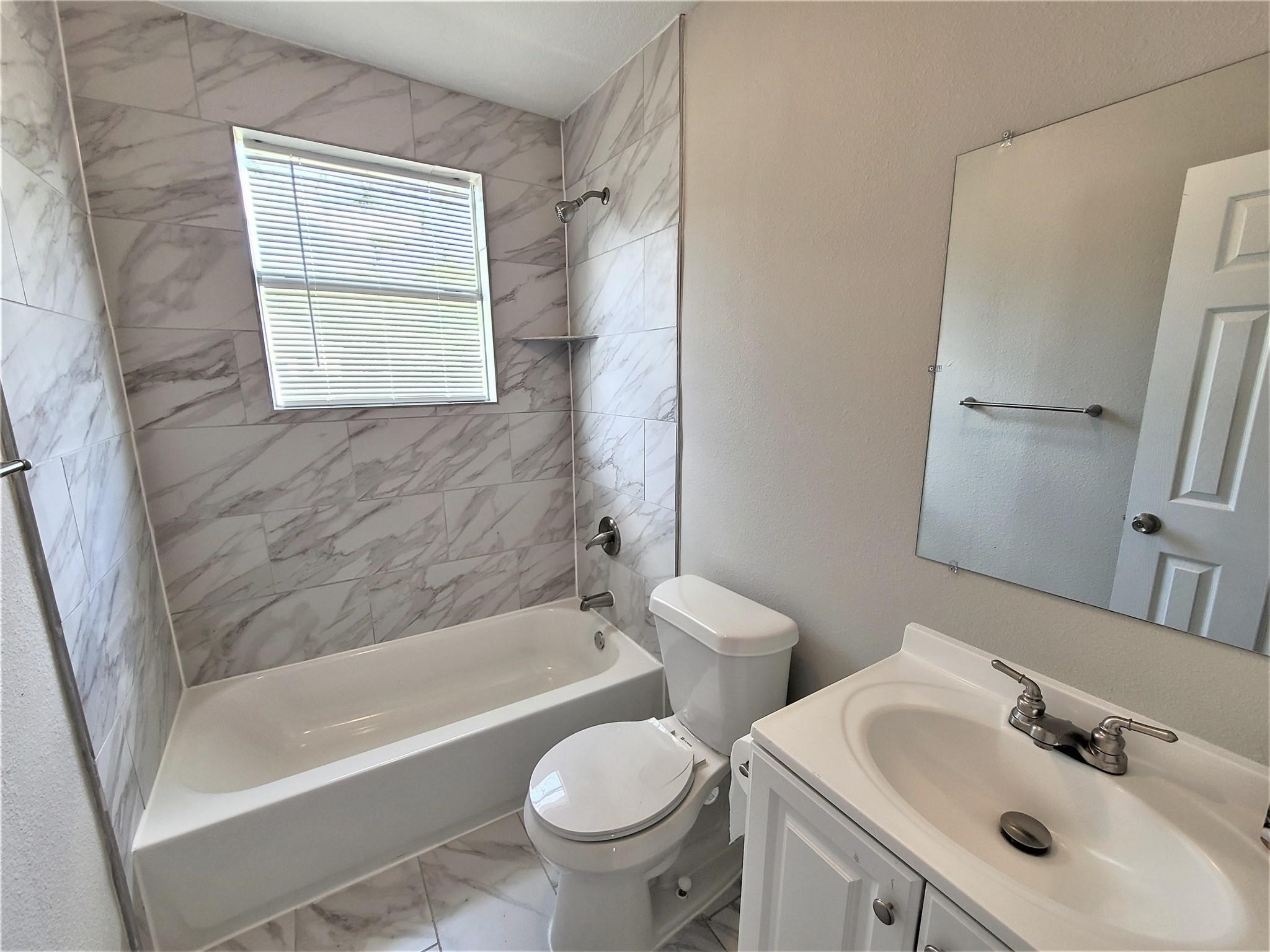 10329 Wicklowe Street Houston, TX 77016 - Photo 9 of 10 a bathroom with a sink toilet and bathtub