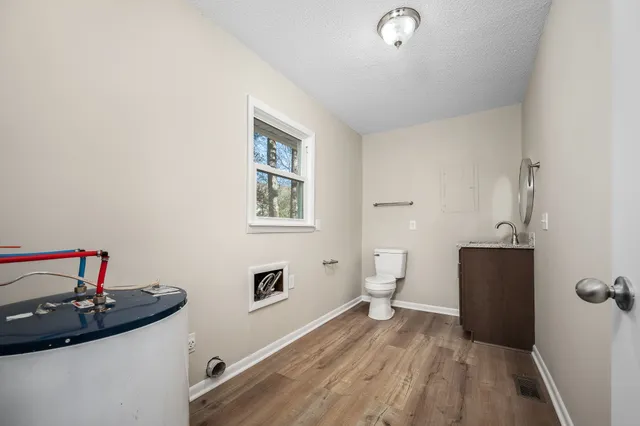 a view of a hardwood floor and a sink in a room
