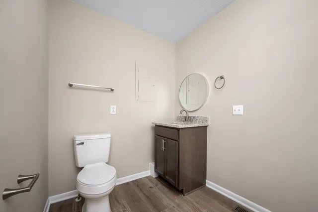 a bathroom with a toilet a sink and a mirror
