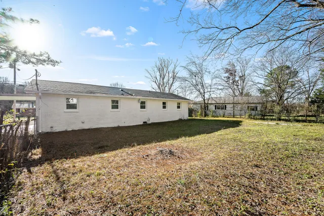 a view of a white house with a yard