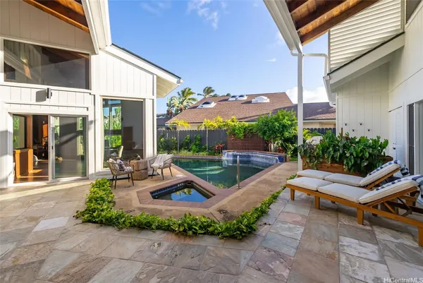 a view of a patio with chairs and potted plants