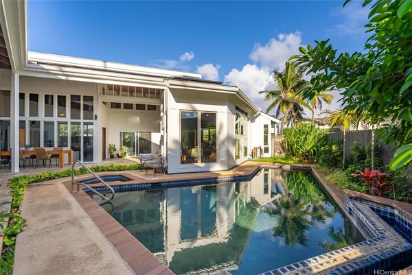 a view of a house with swimming pool and sitting area