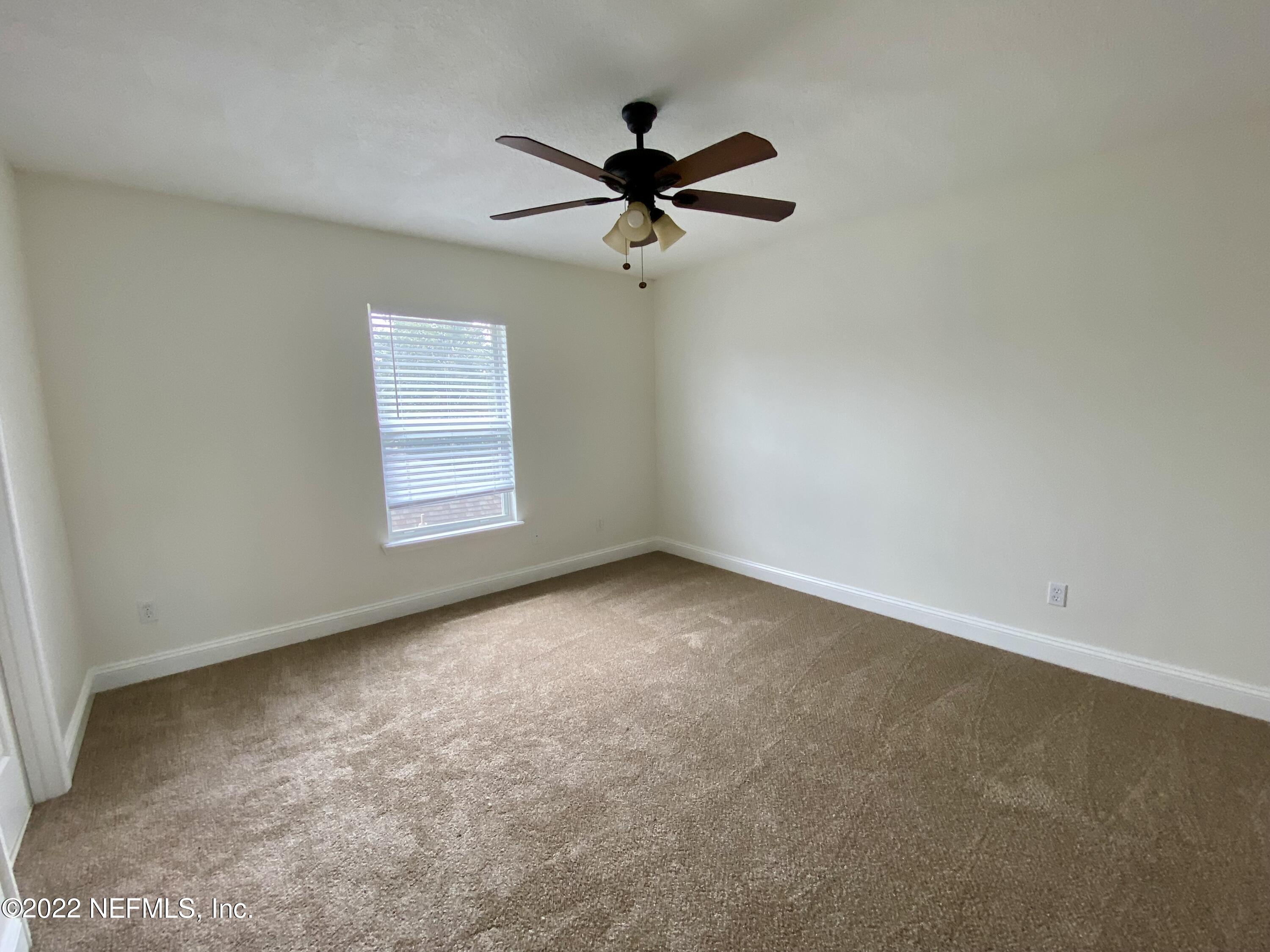1648 Summerdown Way St. Johns, FL 32259 - Photo 12 of 14 an empty room with windows and fan