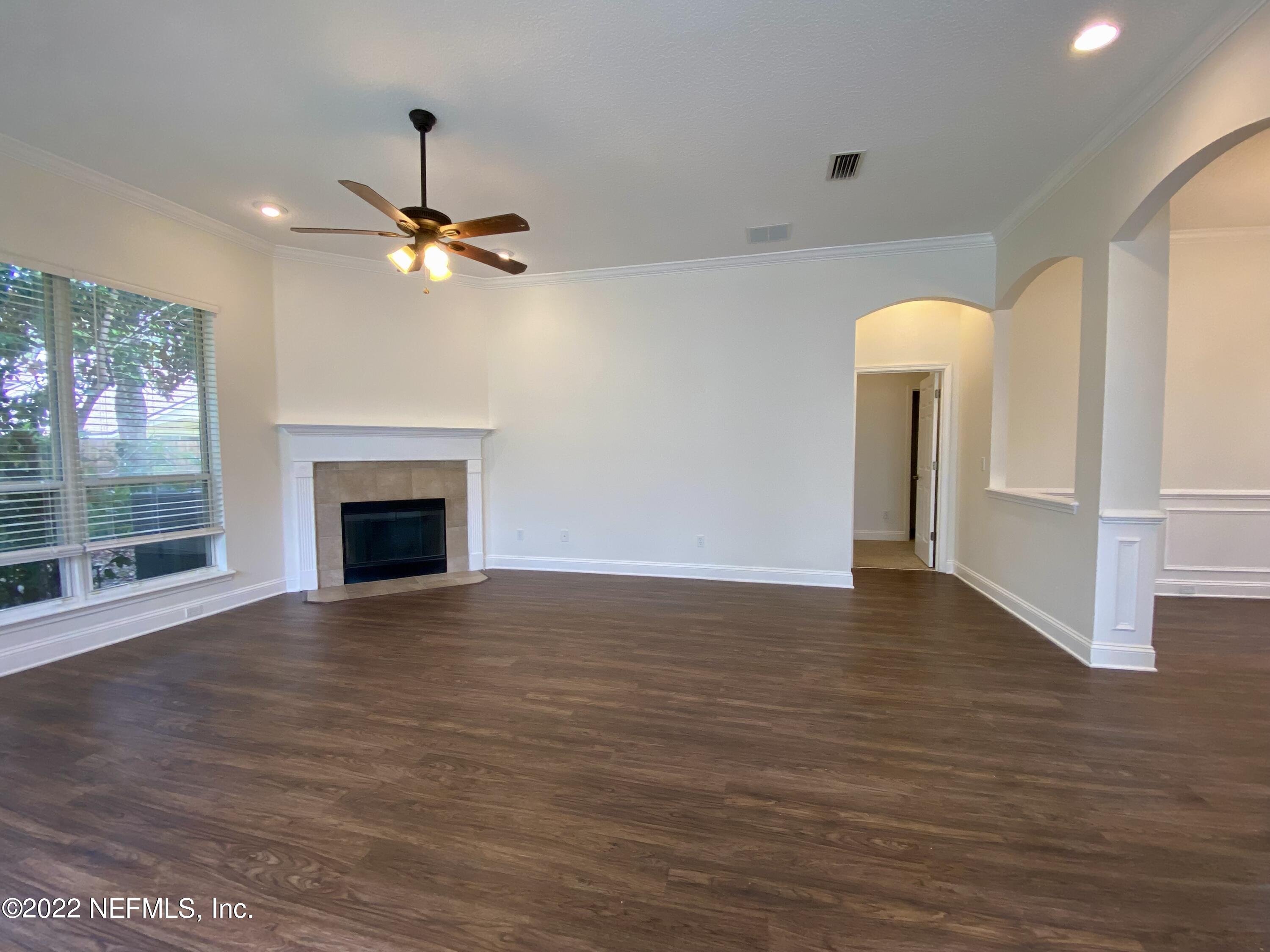 1648 Summerdown Way St. Johns, FL 32259 - Photo 7 of 14 a view of an empty room with glass door and a ceiling fan