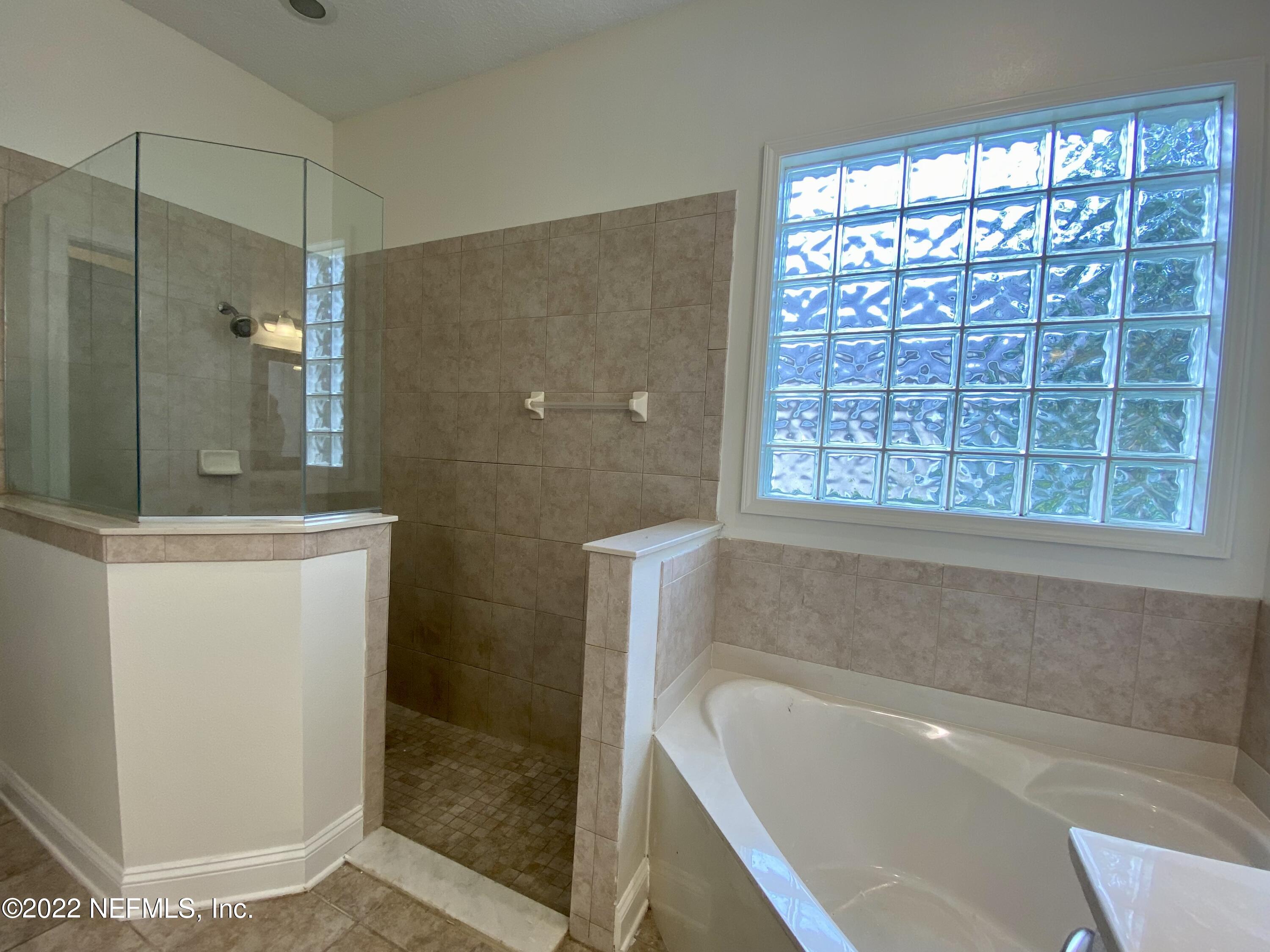 1648 Summerdown Way St. Johns, FL 32259 - Photo 9 of 14 a bathroom with a bathtub and shower
