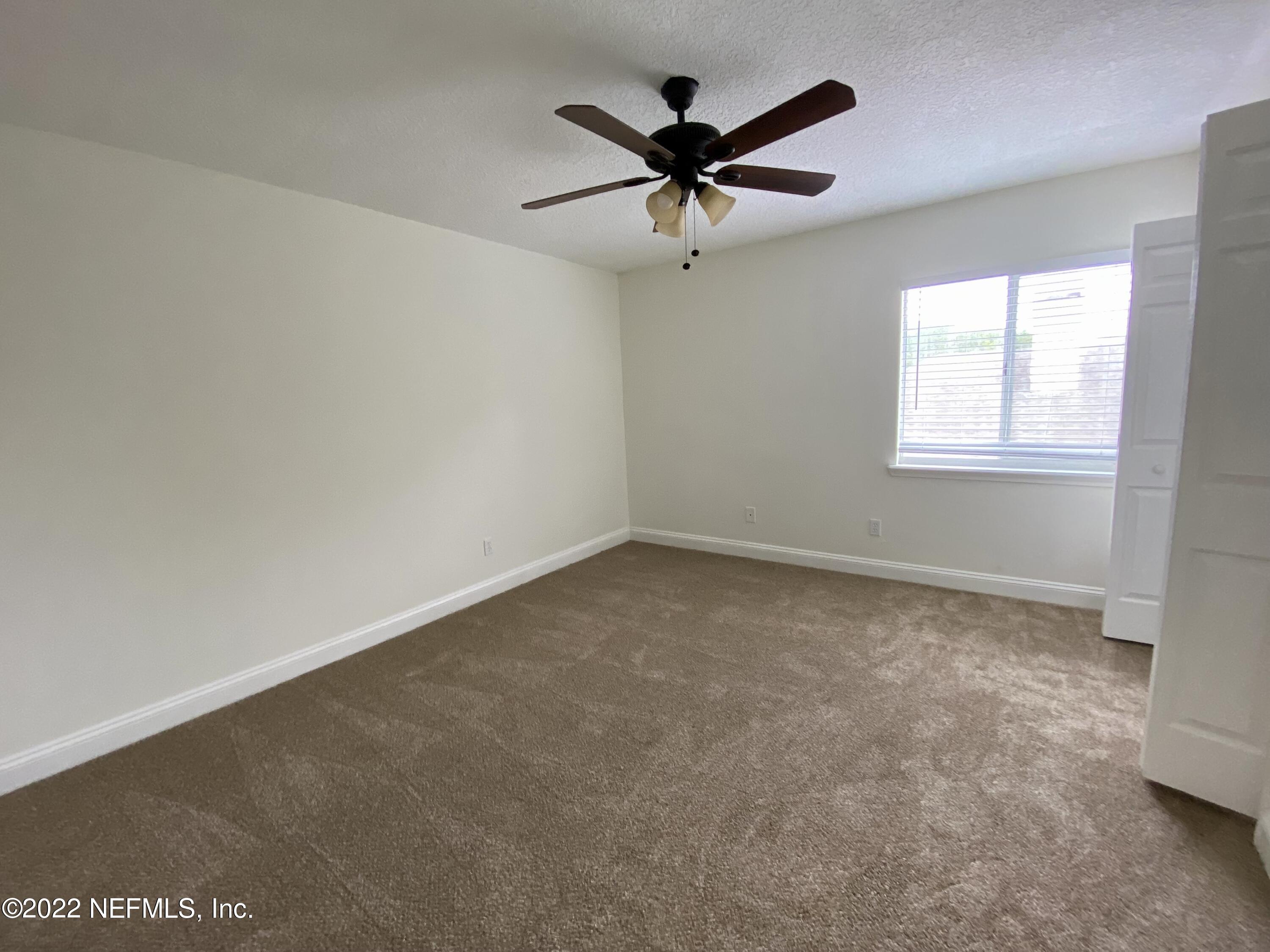 1648 Summerdown Way St. Johns, FL 32259 - Photo 10 of 14 an empty room with a window and a fan