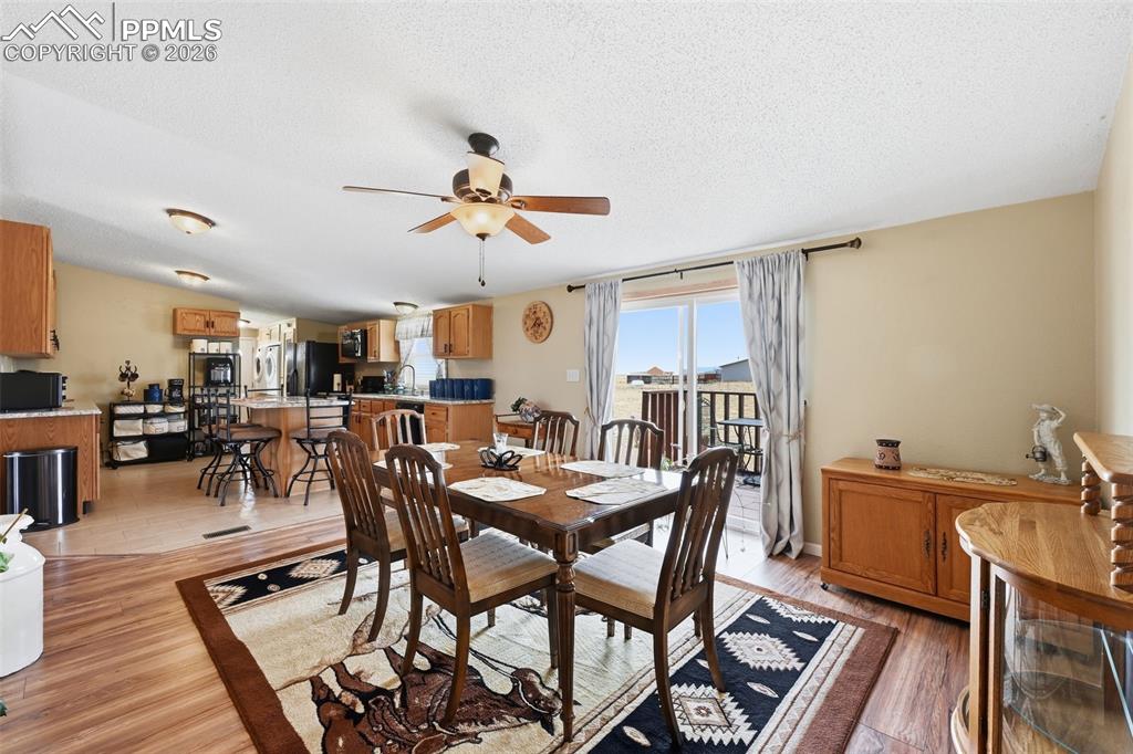 20985 McDaniels Road Calhan, CO 80808 - Photo 27 of 41 a view of a dining room with furniture and wooden floor