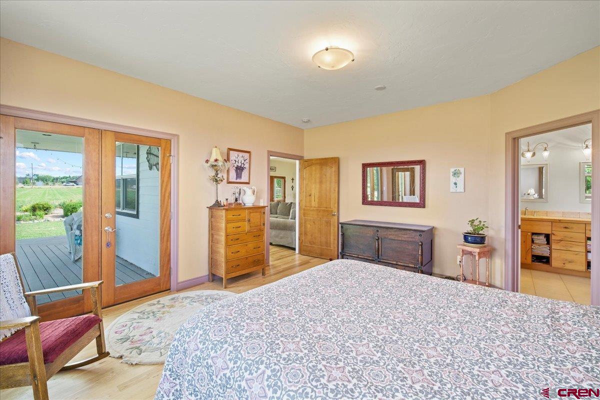 13902 5950th Road Montrose, CO 81403 - Photo 12 of 35 a bedroom with a large bed and a dresser