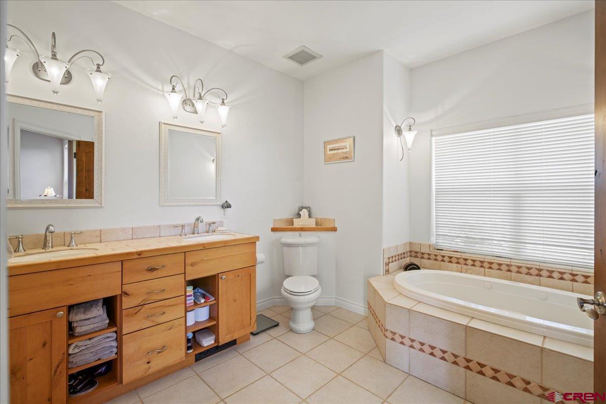 13902 5950th Road Montrose, CO 81403 - Photo 15 of 35 a bathroom with a tub sink toilet and mirror