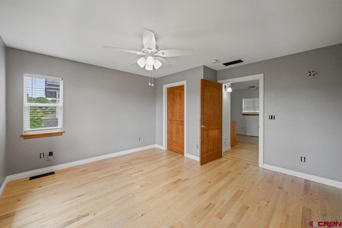 13902 5950th Road Montrose, CO 81403 - Photo 18 of 35 wooden floor in an empty room with a window