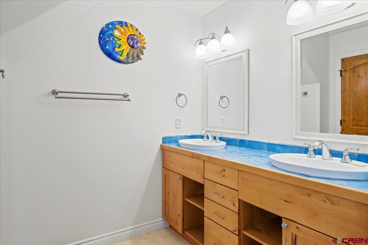 13902 5950th Road Montrose, CO 81403 - Photo 20 of 35 a bathroom with a sink a vanity and a mirror