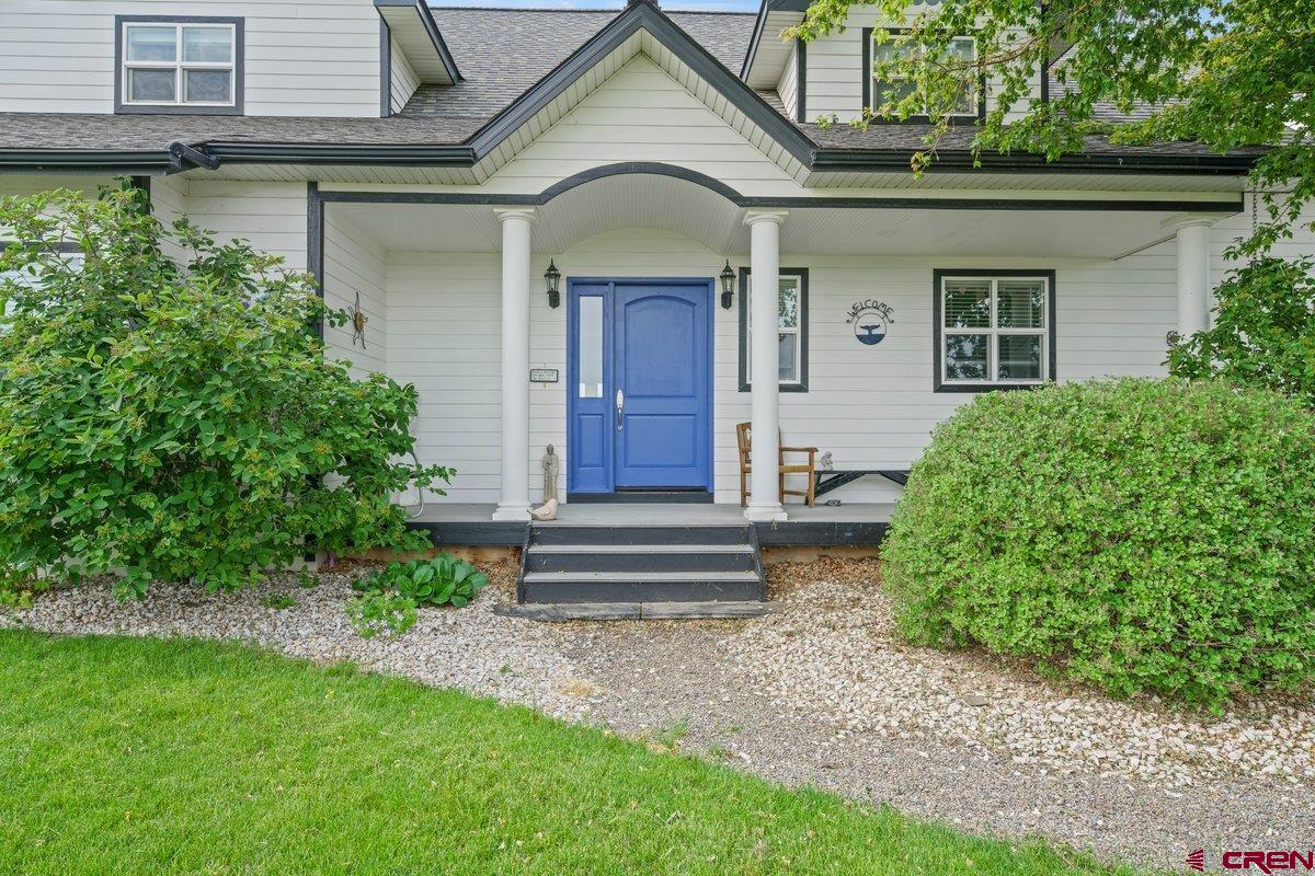13902 5950th Road Montrose, CO 81403 - Photo 2 of 35 a front view of a house with a garden