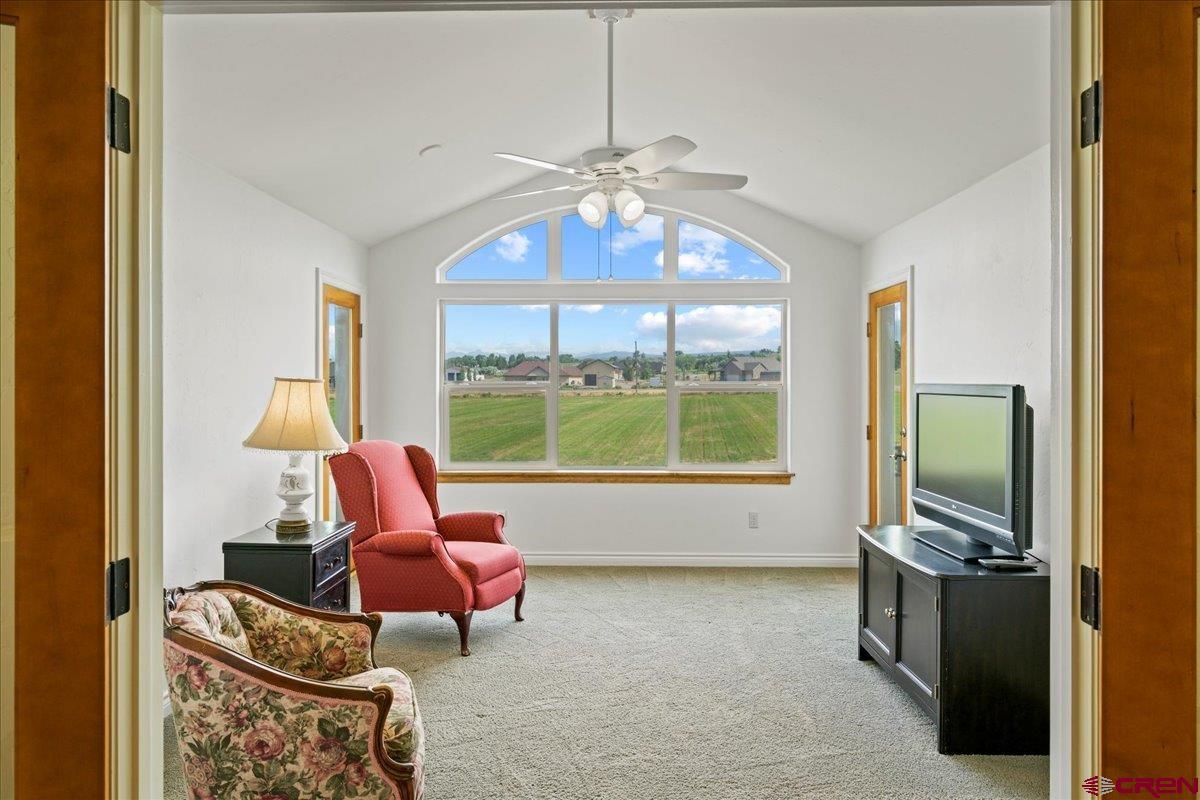 13902 5950th Road Montrose, CO 81403 - Photo 24 of 35 a living room with furniture a flat screen tv and a window