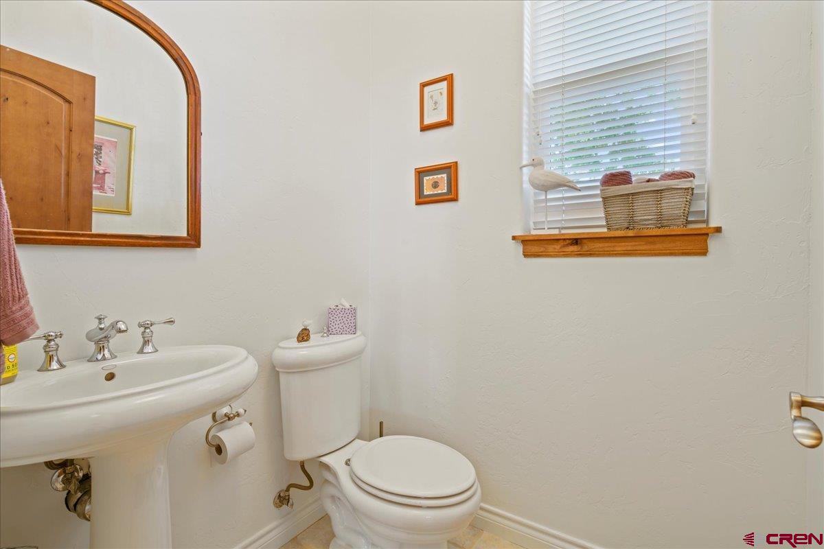 13902 5950th Road Montrose, CO 81403 - Photo 27 of 35 a bathroom with a sink mirror and toilet