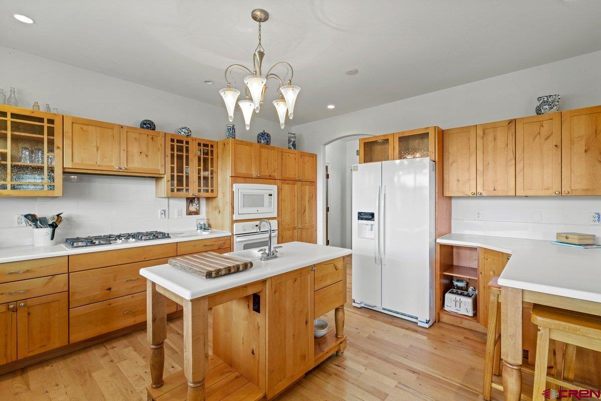 13902 5950th Road Montrose, CO 81403 - Photo 10 of 35 a kitchen with stainless steel appliances granite countertop a sink refrigerator and cabinets